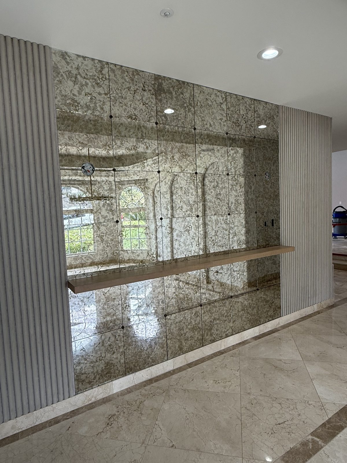 Custom 102-inch gold vein antique mirror feature wall installed in an Anaheim, CA home